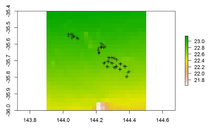 Map of a raster of values from about 21.8 to 23, shaded from pink through yellow to green, with crosses marking sampling sites