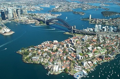 Aerial photo of Sydney Harbour, with the Harbour Bridge, the Opera House and waterfront suburbs