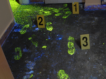 Glowing footprints on a floor at a crime scene, marked with numbered evidence cards